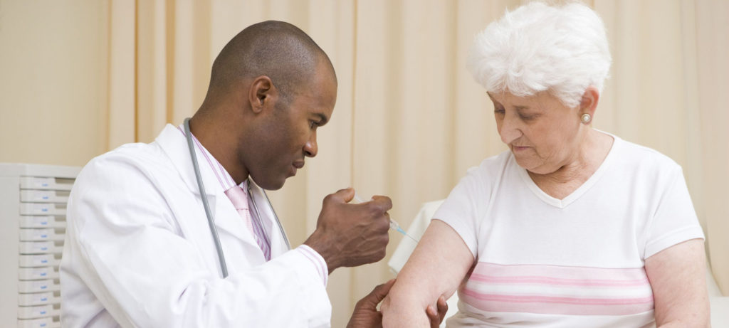 3601254 - doctor giving needle to woman in exam room