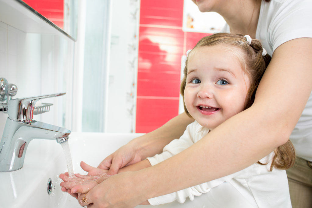 Kid washing hands in bathroom