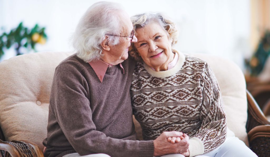 Happy senior man and woman having rest at home