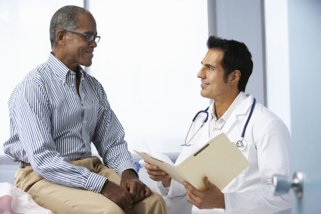 42256499 - doctor in surgery with male patient reading notes